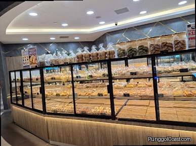 An interior shot of a bakery display case filled with various baked goods.