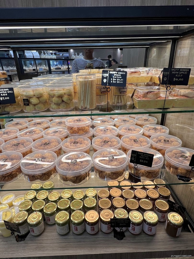 Display case filled with various packaged baked goods and jars of spreads.