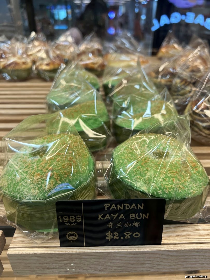 Packaged Pandan Kaya Buns on display with a price tag in a shop.