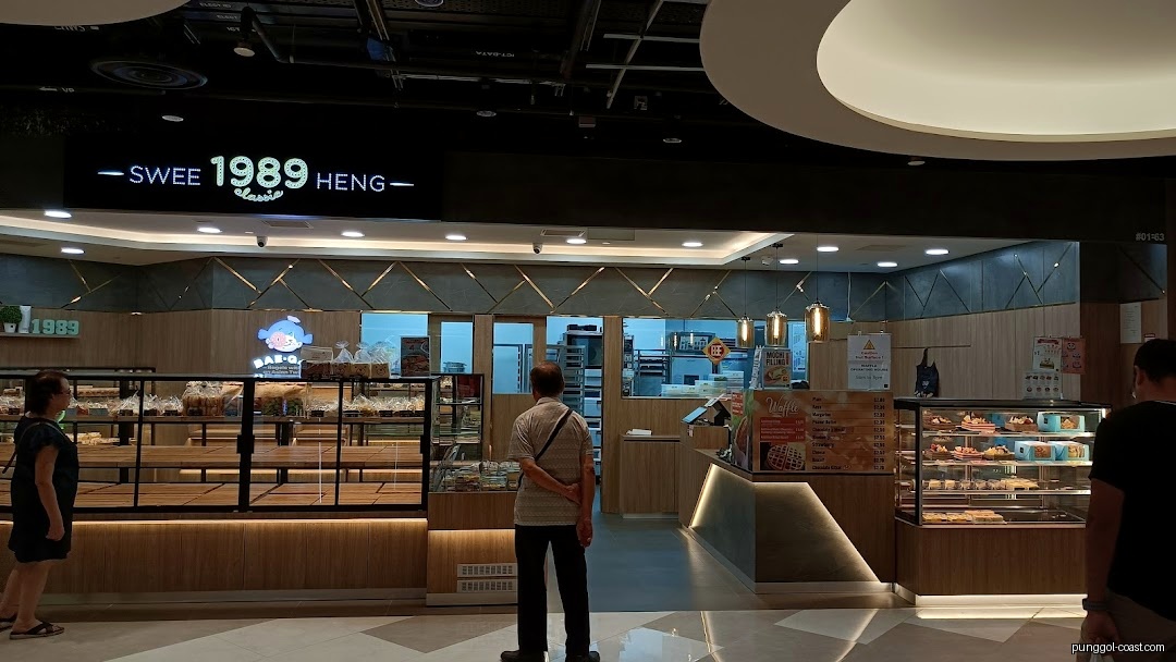 Shop front of Swee Heng 1989 Classic bakery with display cases and customers.