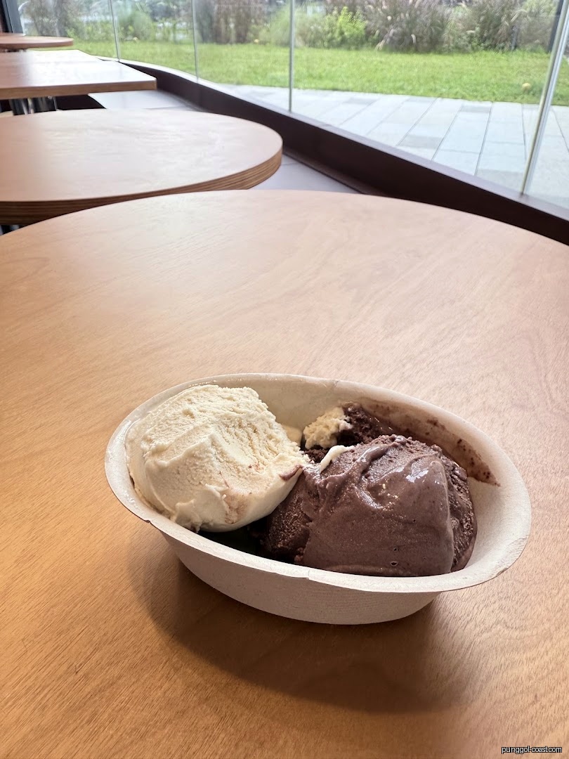 Ice cream in a bowl on a table inside a shop.