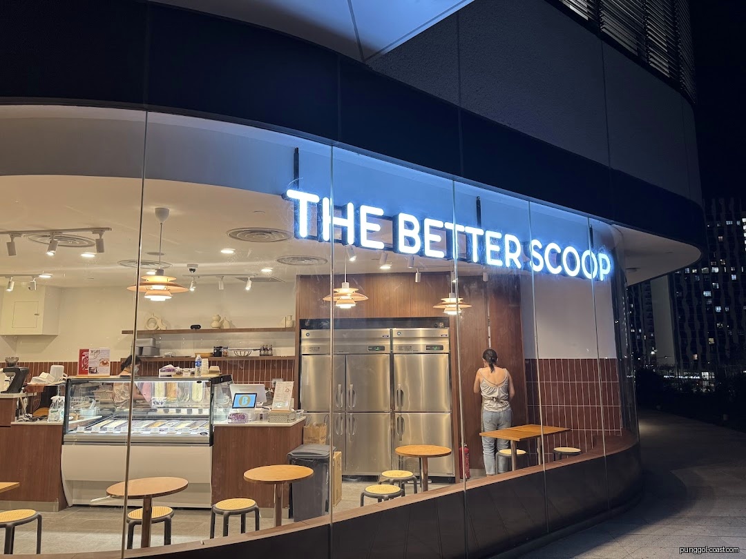 The Better Scoop shop exterior at night with glowing sign.