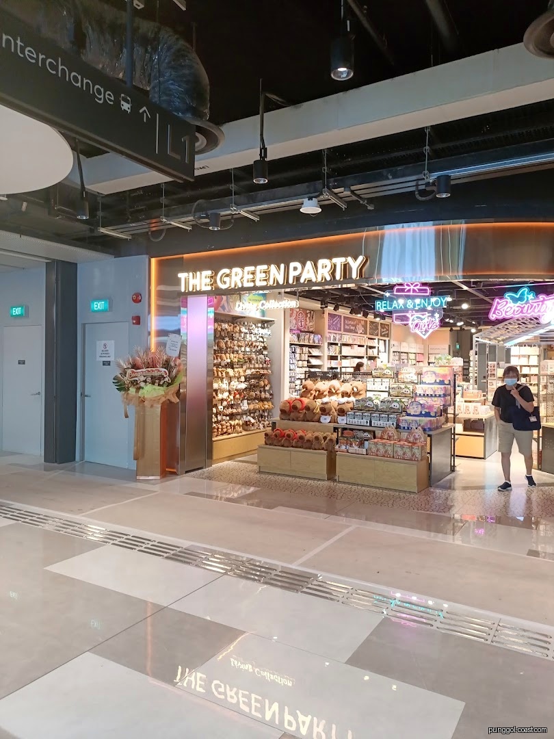 Entrance of 'The Green Party' shop with products displayed and bright signage.
