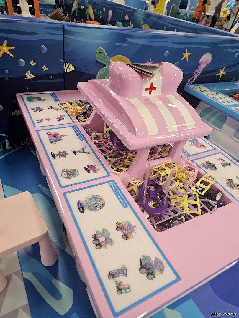 Pink display unit with magnetic toys in an ocean-themed play area.