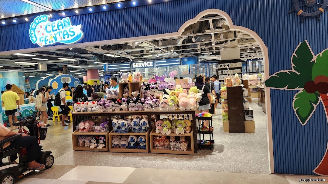 Customers browse plush toys inside an ocean-themed retail shop.
