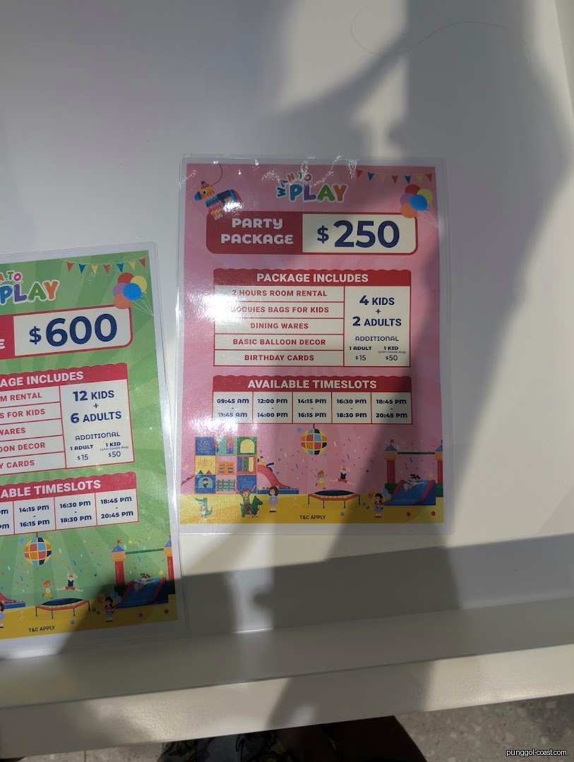 Two signs display party package details, prices, and available timeslots.