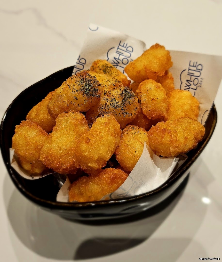 A bowl of golden fried food with seasoning and White Cloud Cafe branding.