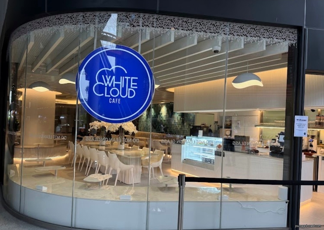 Exterior view of White Cloud Cafe with glass front and interior visible.