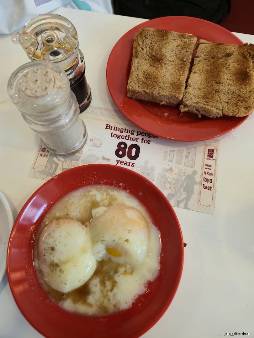 Toast and soft-boiled eggs served on a table.