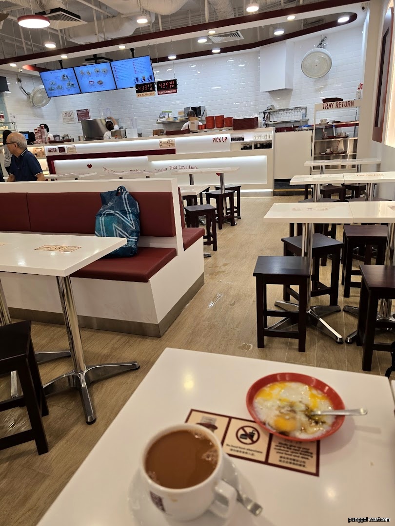 Interior view of a cafe with tables, counter, and food on a table.