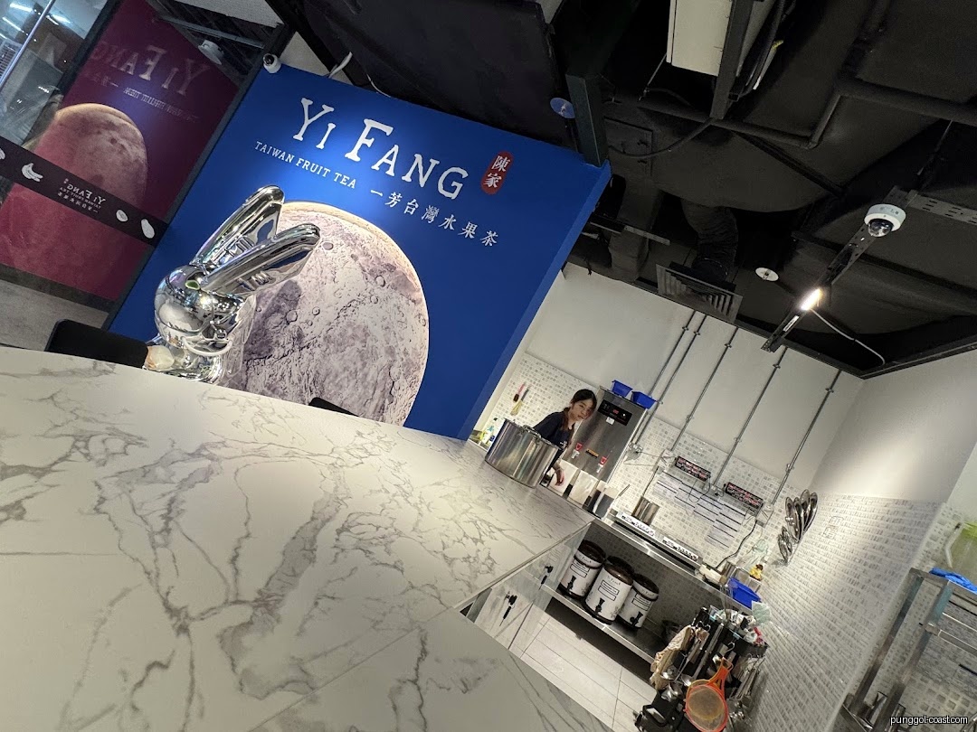 Interior shot of Yi Fang Taiwan Fruit Tea shop with counter and staff.