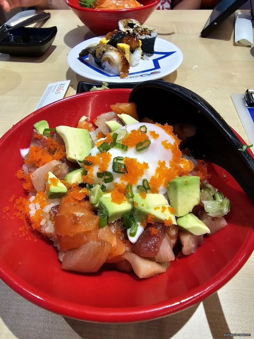 A red bowl of poke/chirashi with avocado, roe, and egg, plus sushi.