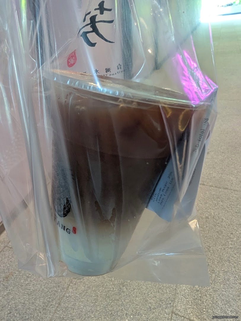 A large layered drink cup from Yi Fang in a plastic bag.